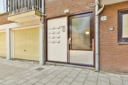 the outside of a building with two garages on each side and an open door at the other end that leads to a balcony