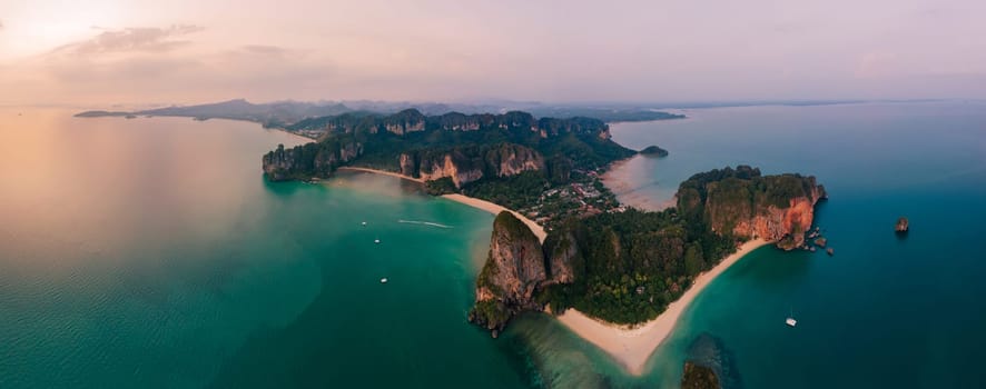 Railay Beach Krabi Thailand, the tropical beach of Railay Krabi, view from a drone of idyllic Railay Beach in Thailand in the evening at sunset with a cloudy sky. Panorama of Railay Beach