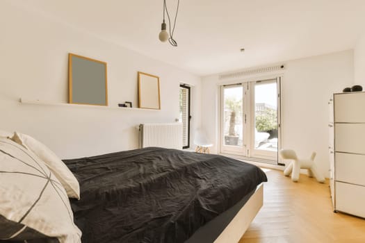 a bedroom with white walls and wood flooring in the fore - image was taken from an insic window