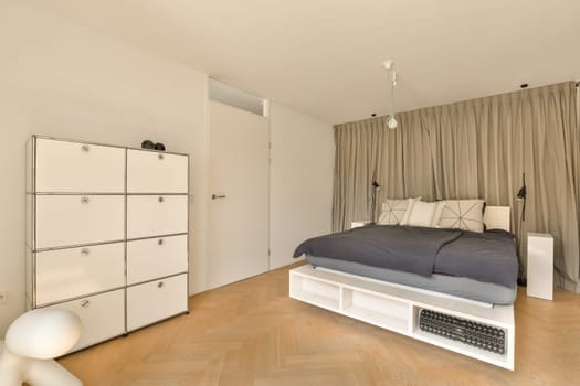 a bedroom with a bed, dressers and cupboards in the same color as they appear on the floor