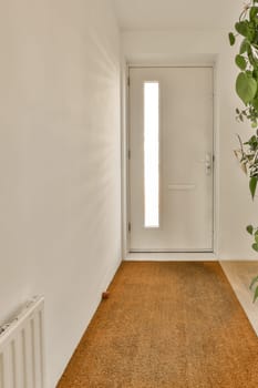 an empty room with a plant in the corner and a door to the right, next to it is a white wall