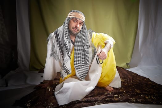 An imposing man in stylized eastern attire, Sheikh or Sultan in Israel, Palestine, and Iran. Photoshoot with a male model