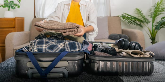 Portrait of beauty asian traveler woman pack prepare stuff and outfit clothes in suitcase travel bag luggage for summer, holiday, weekend, tour, journey, vacation trip at home.