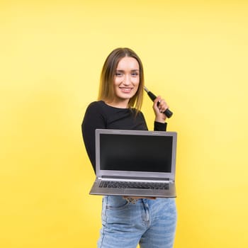 Laptop Repair. Female with hammer and laptop on a yellow background