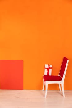 chair with gift in interior on yellow background