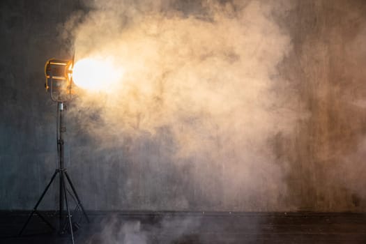 Photographer's lighting equipment in a photo studio with smoke