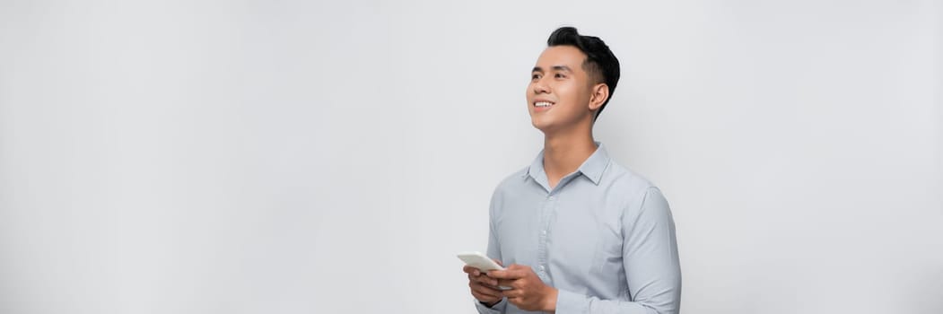 Young asian men wearing casual clothes smiling to using the phone. communication concepts.