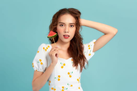 Beautiful young woman with slices of fresh watermelon on color background