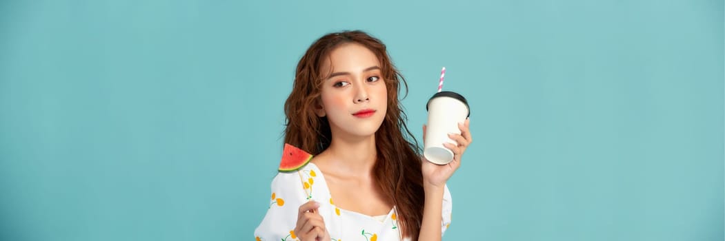 pretty woman drinks a fruit juice from cup holds slice of watermelon ice cream