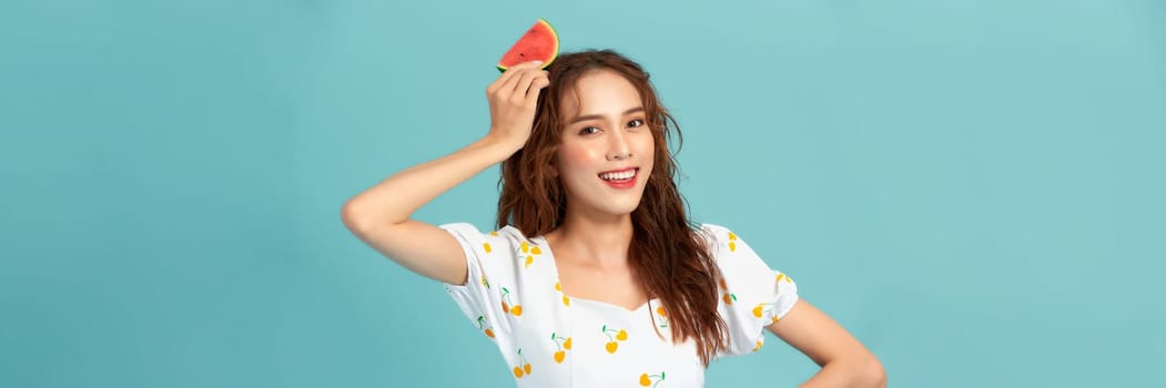 Beautiful happy young woman with fresh watermelon on blue background. Panorama