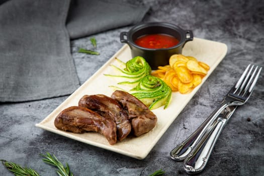 meat ribs with avocado, chips and ketchup on a white plate