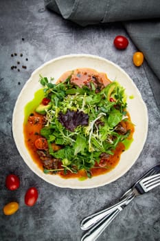 meat gravy with meat, cherry tomatoes and a bunch of greens on top