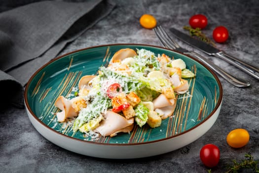 caesar salad with cheese on a blue plate. High quality photo