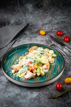 caesar salad with cheese on a blue plate. High quality photo