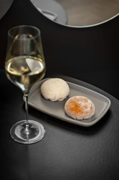 Traditional Japanese dessert mochi and a glass of white wine. High quality photo