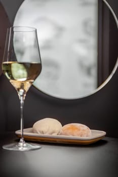 Traditional Japanese dessert mochi and a glass of white wine. High quality photo