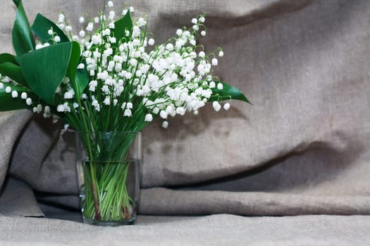 Lilies of the valley in a vase on canvs background