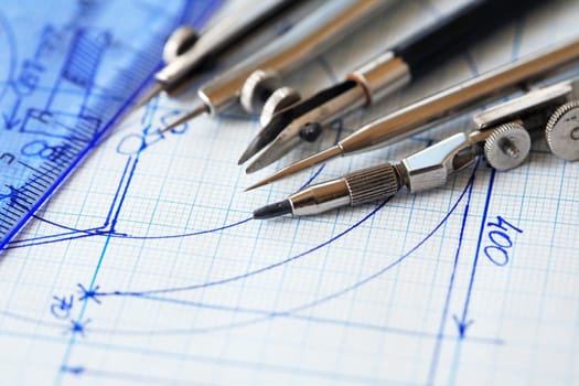 Set of old drawing tools on background with graph paper