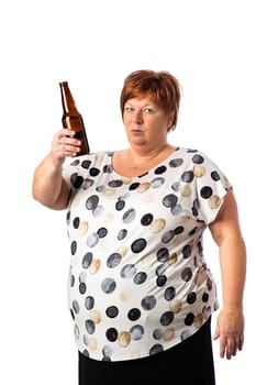 Fifty something woman, cheering with a brown bottle of beer, isolated on a white background