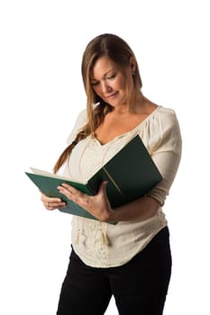 Forty something woman, reading a large green book, isolated against a white background