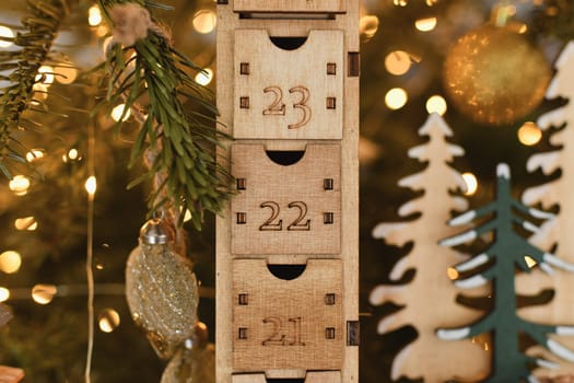Wooden advent calendar near the Christmas tree