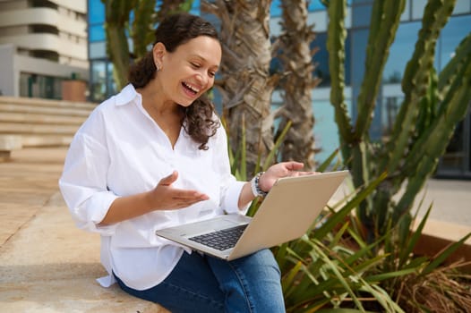 Smiling young multi ethnic pretty woman using laptop, having an online job interview with HR manager via video link. People. Internet and business. Online communication. Career and recruitment concept