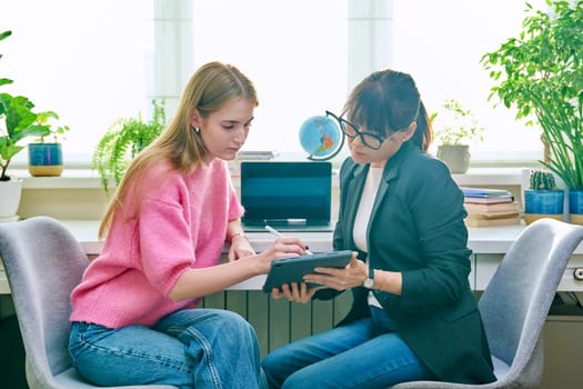 Psychologist, social worker, behavior, counselor talking with teenage girl student, using digital tablet for work. Psychology psychotherapy therapy, adolescence youth, social life, mental health