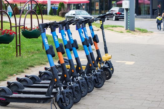 Belarus, Minsk - 20 september, 2023: A row of rental electric scooters on the pavement