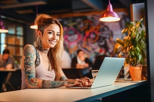 The girl with the tattoo is working on a laptop