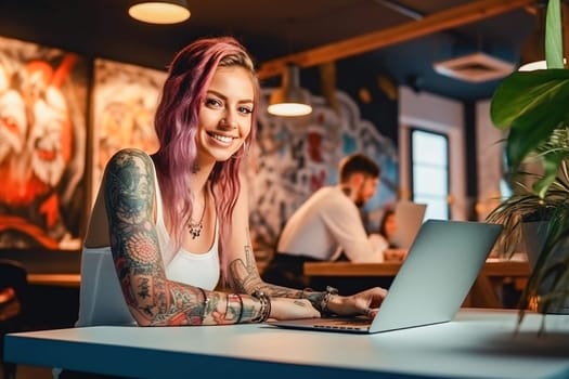 The girl with the tattoo is working on a laptop