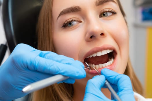 A dentist examining a patients teeth in a modern dental clinic.