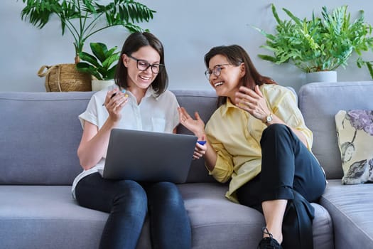 Middle aged woman in individual therapy, female psychologist and patient sitting together on couch in office. Psychology, counseling, psychotherapy, mental health, health care, mature people concept