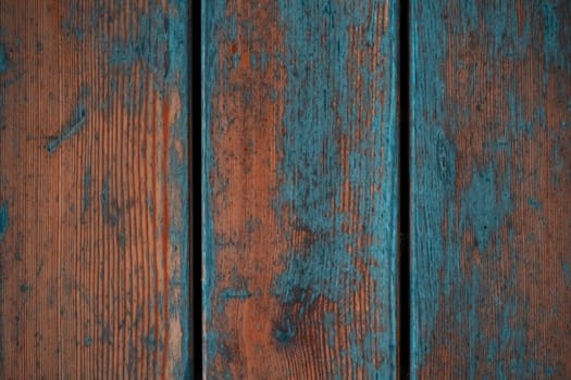 Old beautiful designed boards with scratches and orange, turquoise paint, vintage wooden background.