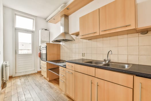 a kitchen with wood cabinets and black counter tops on the island in front of the dishwasher, which has been used for