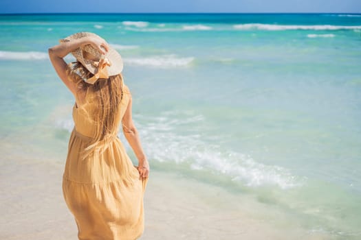 Radiant and expecting, a pregnant woman stands on a pristine snow-white tropical beach, celebrating the miracle of life against a backdrop of natural beauty.