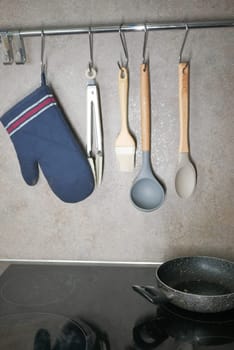 Kitchen utensils hanging on a hanger inside a modern kitchen