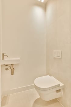 a white toilet in the corner of a walk - in shower room with beige tiles on the walls and floor