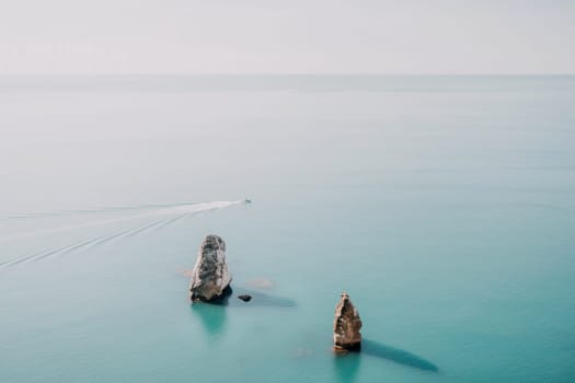 Aerial panoramic view of beautiful sunset above sea. Beautiful seascape. Sun glare, small waves on the water surface. Evening. Horizon. Nobody. No people. Copy space. Never-ending beauty of nature