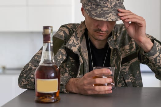 Upset young man drinker alcoholic sitting at bar counter with glass drinking whiskey alone, sad depressed addicted drunk guy having problem suffer from alcohol addiction abuse, alcoholism concept. High quality photo