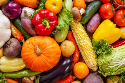 Assortment of the fresh ripe vegetables on wooden background. A collection of fresh and delicious vegetables. Healthy organic food concept.