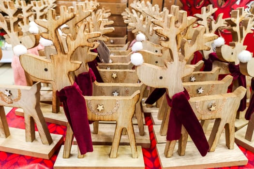 Deer animal toys for sale in a souvenir shop. Traditional wooden toys deer. Christmas wooden animal toys. Christmas market.