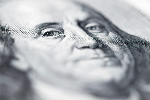 Benjamin Franklin's eyes from a hundred-dollar bill. The face of Benjamin Franklin on the hundred dollar banknote, backgrounds, close-up. 100 dollar bill with only eyes of Benjamin Franklin