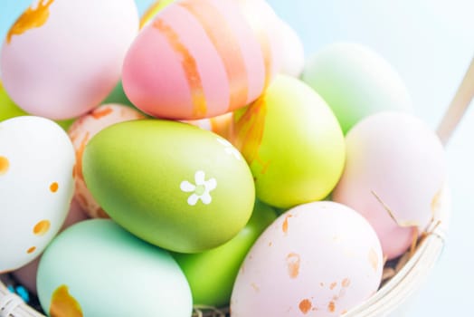 Easter basket filled with painted Easter eggs. Colorful painted Easter eggs in basket.