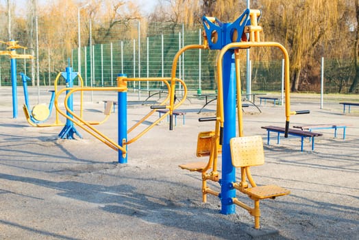 Outdoor gym in the public garden. Outdoor fitness equipment in public park. Sports simulators in the park.