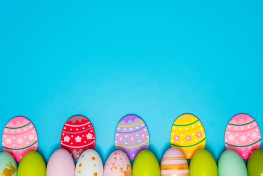 Easter Eggs. Colorful Easter eggs on blue background with copy space. Easter background.