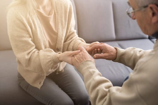 Close up anxious serious old man listening to female doctor at meeting in hospital, therapist physician consulting mature patient about disease, treatment, elderly generation healthcare concept.
