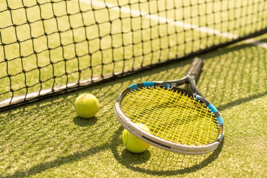 tennis racket with a tennis ball on a tennis court.
