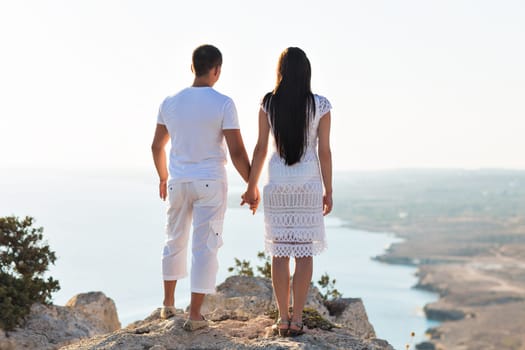 couple of young men and woman hugging and looking at the distance