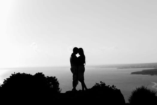 silhouette happiness and romantic scene of love couples partners on top of the mountain