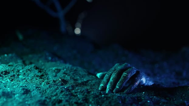 Zombie woman hand crawl in soil on grave. Creepy halloween moment, undead.Cemetery, halloween concept. Living nightmare comes to life. High quality